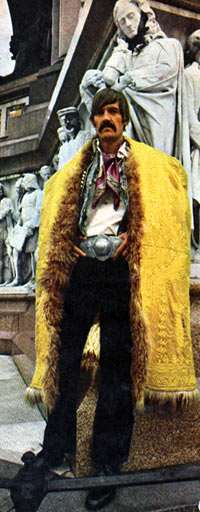 Jaunty: Millionaire Michael Butler, jet-set producer of HAIR, strikes a statuesque pose wearing his Tibetan saffron cloak.